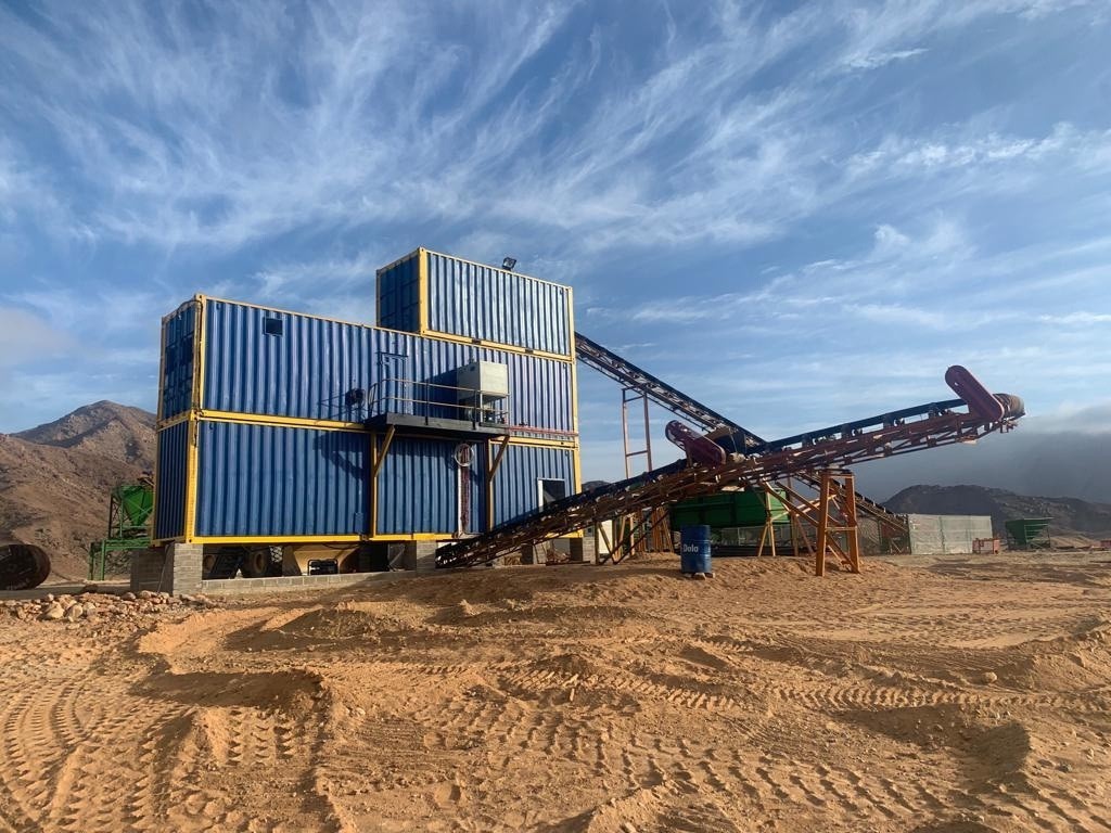 Blue container processing plant with its conveyor running across arid Northern Cape ground